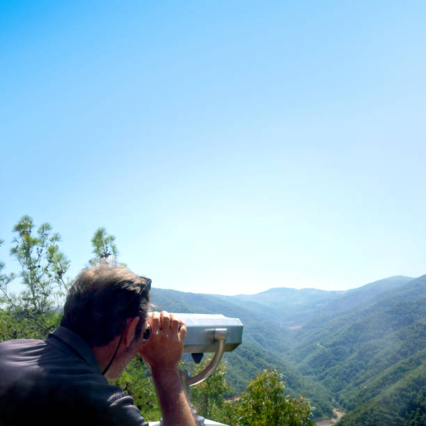 istock Mid adult man looking at view with coin operated binoculars 2087782955