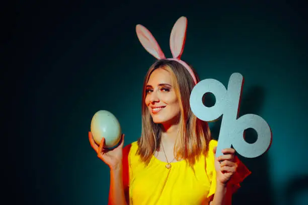 Photo of Happy Woman Holding a Huge Easter Egg and a Discount Symbol