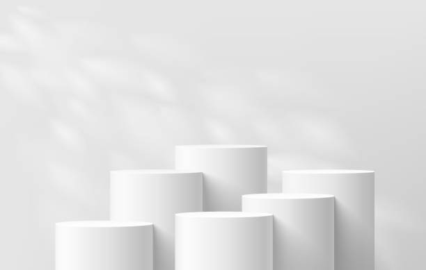 istock 3D background with set of realistic white cylinder podium pedestal and natural leaf light scene. Abstract composition in minimal design. Platforms mockup product display presentation. Stage showcase. 2087834900