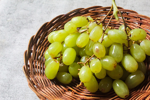 bunch of green grapes in a basket