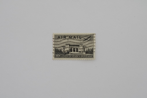 This ten cent, grey stamp depicts air mail with an airplane