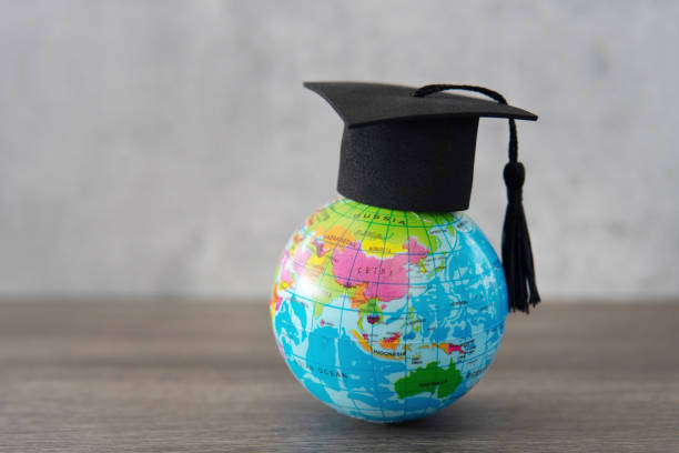 istock Graduation cap on top of world globe with copy space. 2088009291