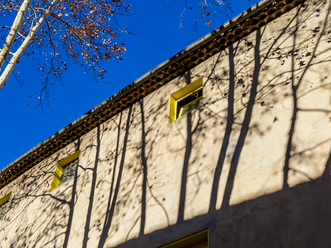 Close up house with tree shadows in Toulon, France