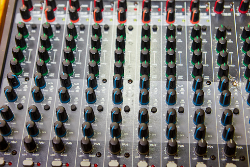 Volume and equalization controls on professional mixing console