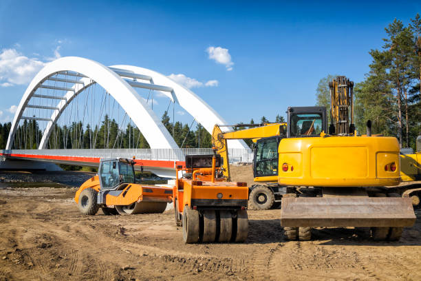 Road construction machines on the road and bridge construction site at Dunajec River in Malopolskie province, Poland