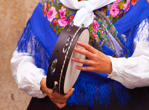 Woman playing  tambourine in the street, wearing historical clothings. Lugo city, Galicia, Spain during San Froilán autumn traditional celebrations.