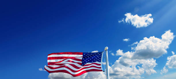 istock American flag at flagpole over sunny blue sky 2088126168