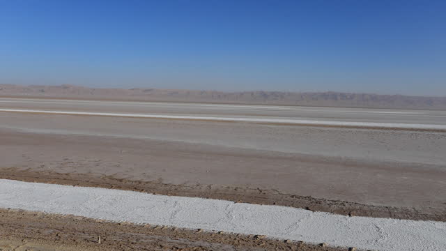 Vast Tunisian salt desert under clear blue sky, Chott el Jerid