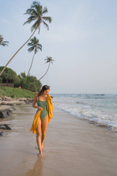 istock Young woman enjoys beach 2088136557