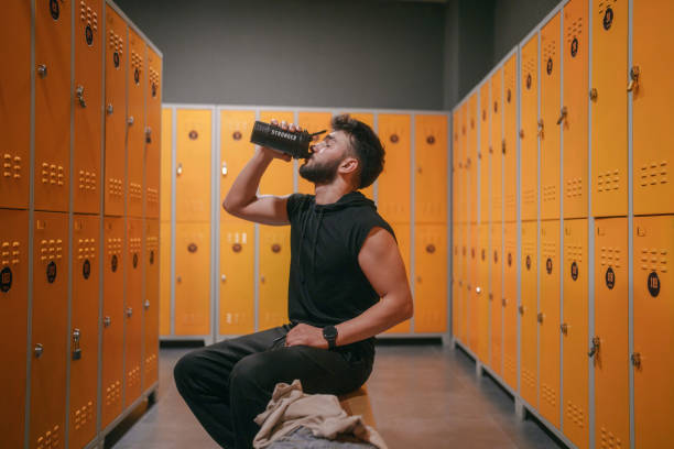 Young man in locker room, at the gym.