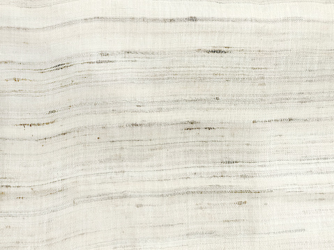Close-up view of different color hand woven natural fiber cotton fabric material, also known as khadi in Eastern India, khadi texture original fabric of india, cotton khadi textile material.