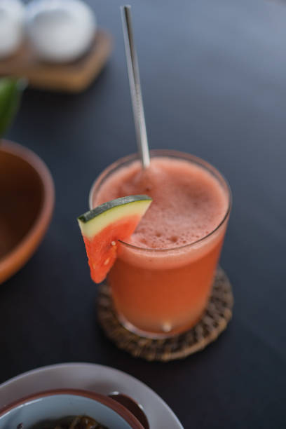 Fresh energy drink with eco-friendly straw on wooden table
