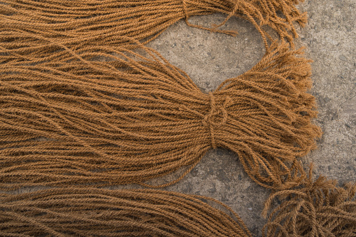 Detail of coconut husk fiber rope lying in bunches on table