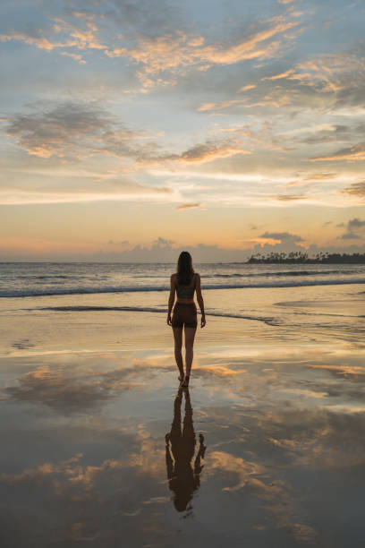 Young woman walks across tidal flats