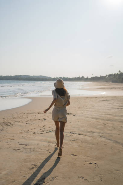 istock Young woman enjoys beach 2088237045