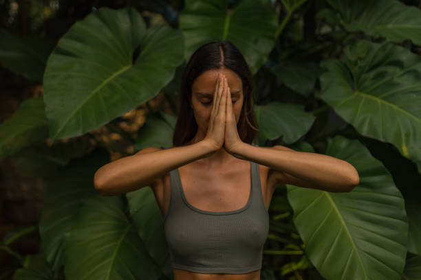 istock Young woman performs breathing exercises 2088242831