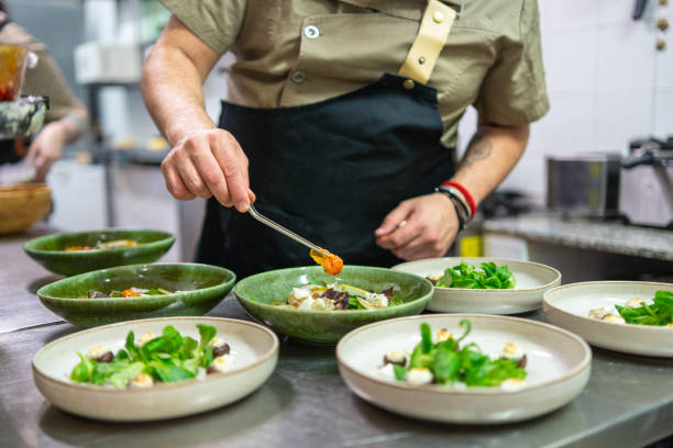 istock Chef arranging food on plates 2088259551