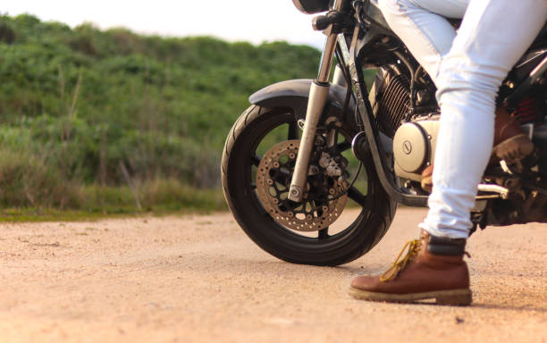 istock Motorcycle on a road with unrecognizable man boots 2088328301
