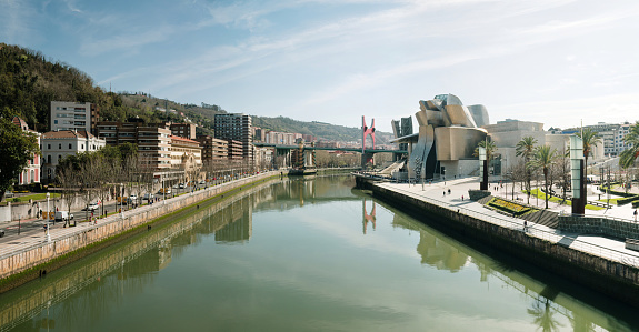 Bilbao, Spain - 15 March 2024: A general view of Bilbao by the Nervion river, with the Guggenheim museum building, designed by Frank Gehry