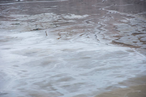 Muddy waters in a decantation pond. Toxic residuals from a copper mine decating in a settling basin