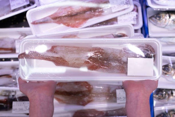 Child's hand holding squid in a pack