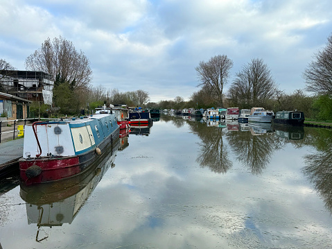 Northamptonshire, UK - May 25, 2022. Narrowboats or canal barges in a lock on the Grand Union Canal at Stoke Bruerne village
