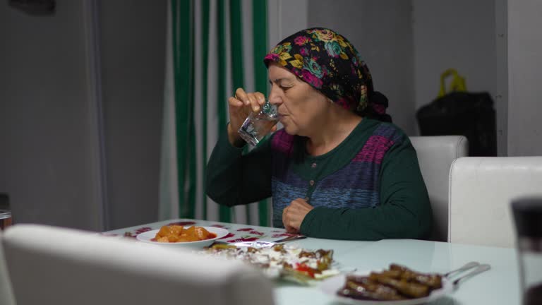 Iftar meal during Ramadan, woman breaking her fast, Turkey