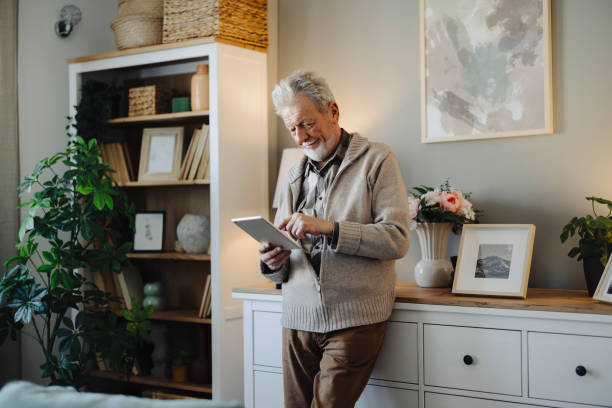 Portrait of senior man using digital tablet at home