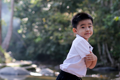 Portrait of an Asian young boy at nature reserve forest