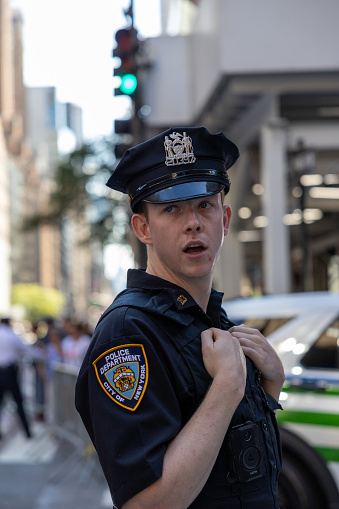 Manhattan, New York, USA - September 20, 2023: An NYPD officer in uniform at an intersection on 5th Avenue during the passage of the presidential motorcade