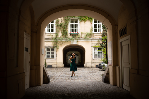 Fashionable young woman standing on the street in downtown Vienna.