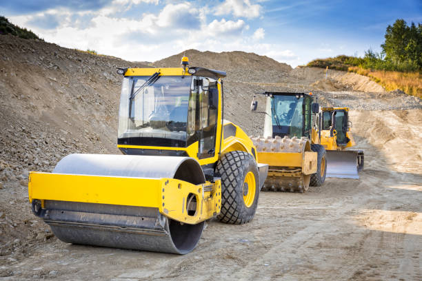 Road construction site in the city center and asphalt paving machine.