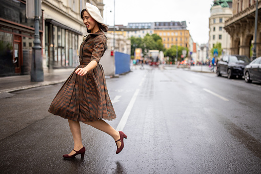 Fashionable young woman walking on the street in Vienna.