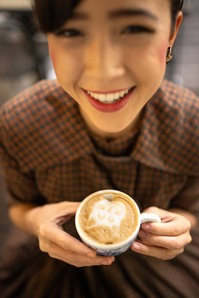 Modern young woman enjoying in coffee in cafe.