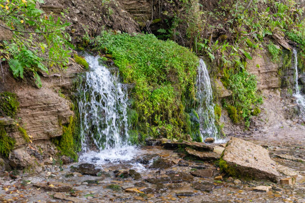 istock A small beautiful waterfall on a hillside in the forest. 2088532843
