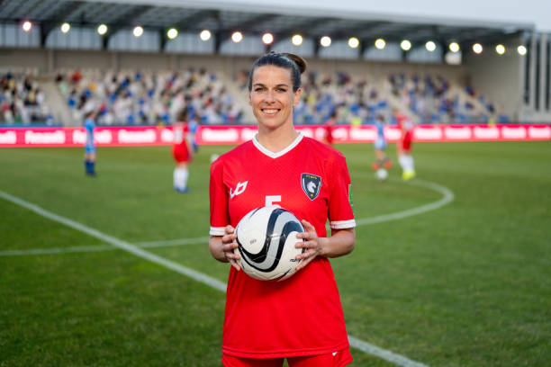 istock Confident Female Soccer Player Holding Ball on Field 2088538996