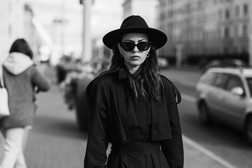 Gothic woman portrait in black coat. Street style.
