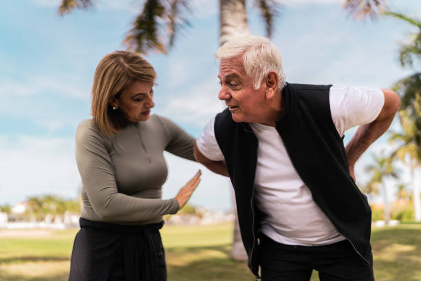 istock Senior man feeling back pain and wife help at public park 2088563855