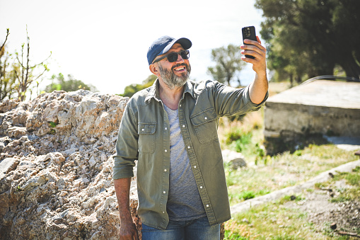Mature adult man traveler with mobile phone