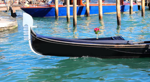 gondola in Venice a traditional boat for tourists on the canal detail of the front of a gondola in Venice a traditional boat for tourists on the canal venice italy grand canal honeymoon gondola stock pictures, royalty-free photos & images