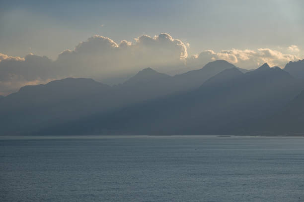 The weather is cloudy.Mediterranean view, mountain range, sunset, snow on top of the mountain
