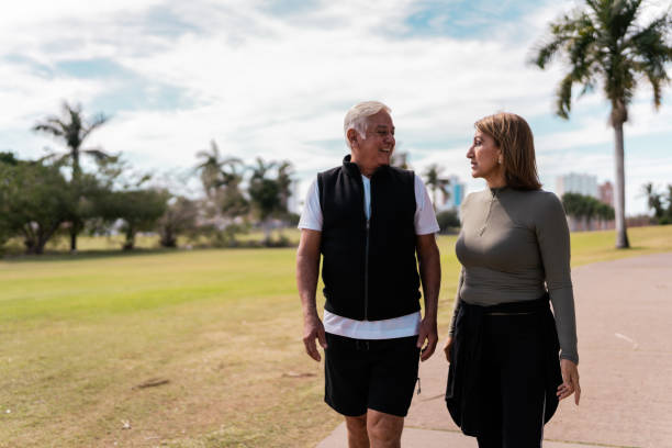 istock Senior couple walking and talking at public park 2088621540