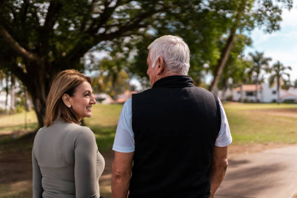 istock Senior couple walking and talking at public park 2088621561