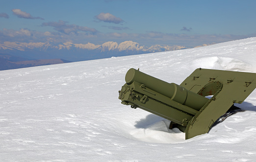 ancient cannon from the First World War completely submerged by snow in winter