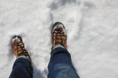 boots of hiker during trip on fresh snow in the mountains in winter