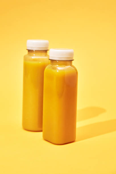 istock Variation of Smoothies in Recycled PET Plastic Bottles on Yellow Background 2088654316