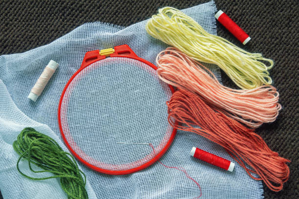 istock Hobby concept, cross stitch. Embroidery frame with canvas, colorful threads. Flat lay, copy space 2088680907