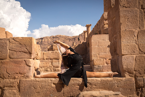 Young woman dance in the ruins of Petra, the ancient city