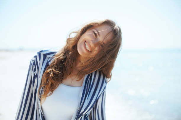 istock smiling modern female on ocean shore having fun time 2088746999