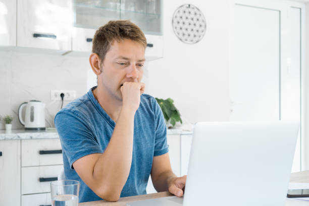 istock Thoughtful attractive man working on laptop online at home, using internet. Concentrated male freelancer using computer for distance work. Remote job 2088860275